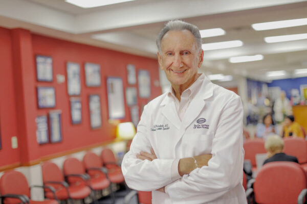 Smiling doctor in a patient waiting room