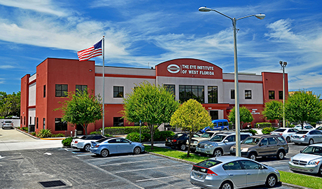 Outside view of The Eye Institute of West Florida location in Largo, Florida. Office building with cars in the parking lot.